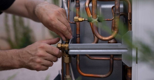 technician installing a heat pump